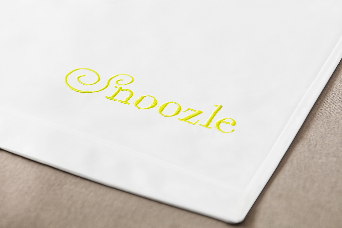 Snoozle logo embroidered in lime green
