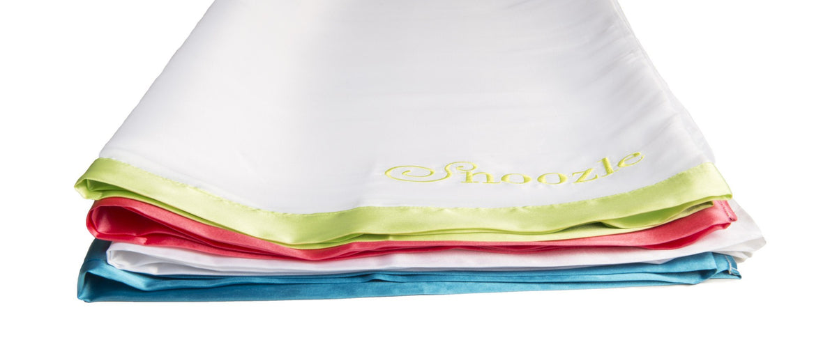 Four folded Snoozle slide sheets with lime, red, white and blue trim